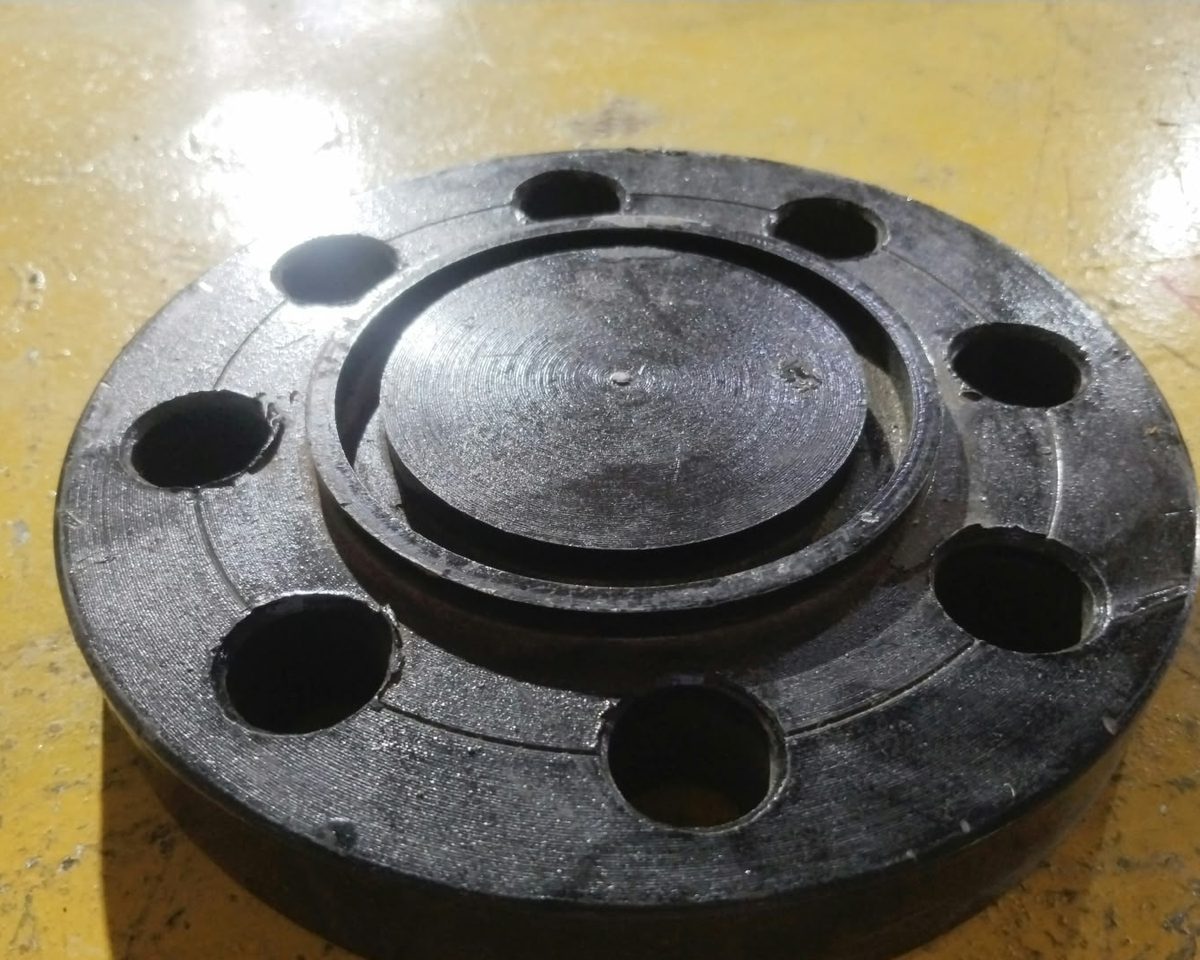 Carbon steel raised face blind flange with eight bolt holes
