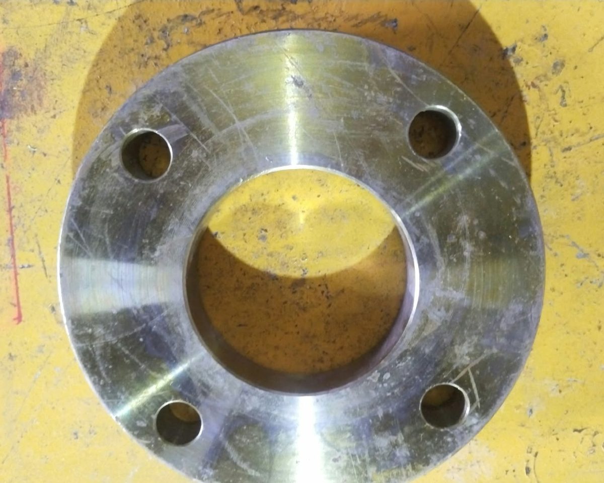 Flat face flange with four bolt holes, the whole face machined flat