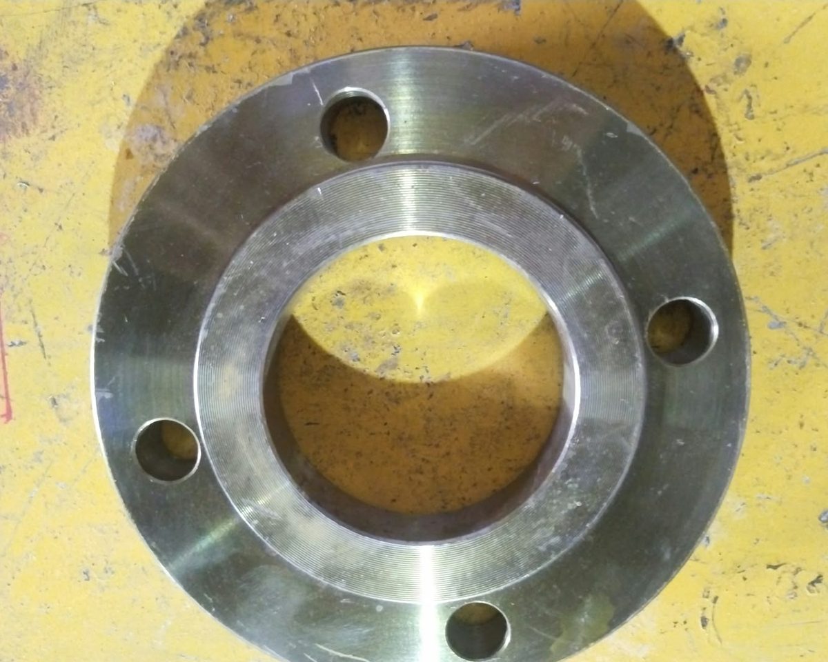 Slip-on flange with a raised face and four bolt holes, photographed at the RIC works